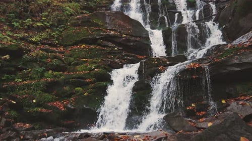 Waterfall Falling Down Mountain Slope in Autumn Forest