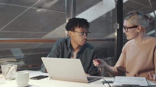 Joyous Diverse Man and Woman Smiling at Camera at Office Desk