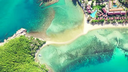 Beautiful turquoise lagoon surrounding vacations resort on tropical island with green lush vegetatio