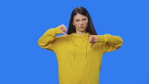 Young Woman Giving Thumbs Down Hand Gesture