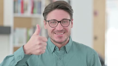 Adult Man Giving Thumbs Up and Nodding