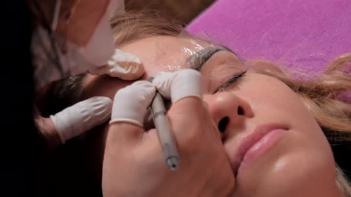 Woman Receiving Cosmetic Eyebrow Treatment Close Up