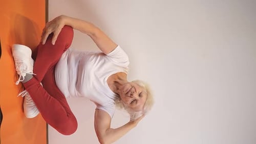 Senior Woman Doing Yoga Stretches at Home
