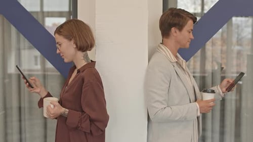 Young Adults Using Smartphones in Office