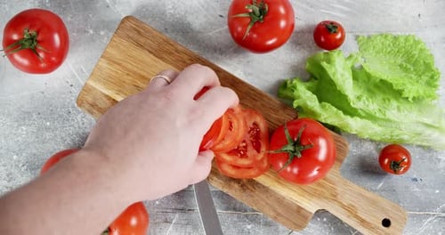 Male Hand Laid Out Pieces of Tomato on the Cutting Board.