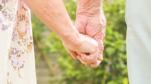 Senior Couple Holding Hands in Garden Close Up