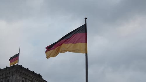 German Flag Waving Against Overcast Sky