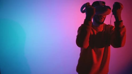 Young Adult Using VR Headset and Controllers