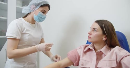 Healthcare Professional Giving Arm Injection to a Patient