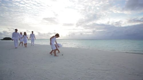 Family of Six Walking at Sunset on the Beach