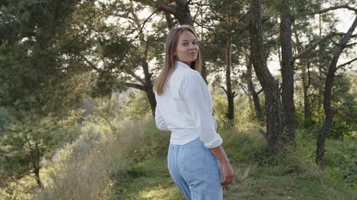 Woman Walking in Forest, Turning to Smile