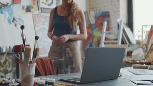 Artist Paints, Then Types on Laptop in Studio