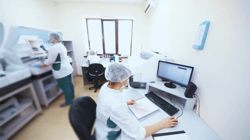 Scientists Working in Bright Hospital Laboratory
