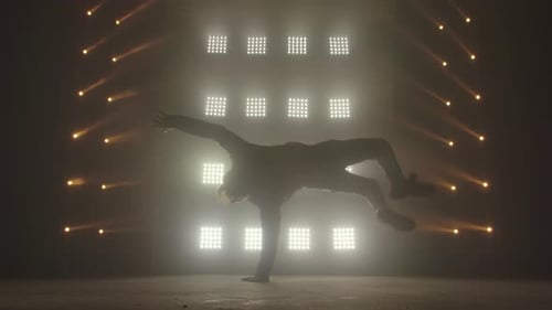 Breakdance Concept. Trendy Young Man Dancing Single in Club, Neon Light, Lots of Smoke. Fashion