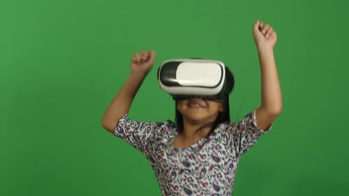 Happy Child Enjoying Virtual Reality Headset on Green Screen