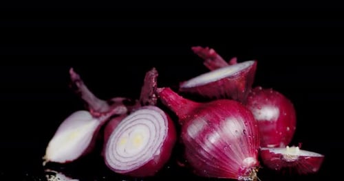 Red Onions with Water Droplets on Black Background