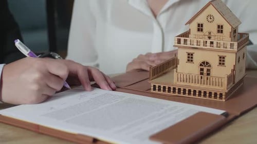 Close Up Of Real Estate Agent Explaining About House Purchase Contract Before Signing On The Paper