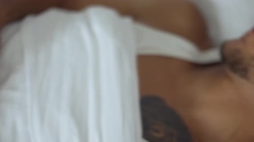 People Bedtime and Rest Concept Close Up of Man with Smartwatch Sleeping in Bed