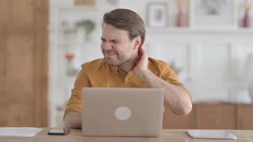 Man at Desk Massaging Stiff Neck