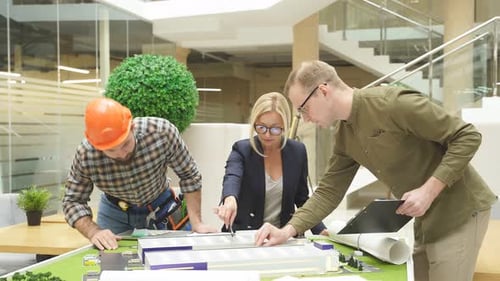 Engineers Working in Office with Building 3d Model