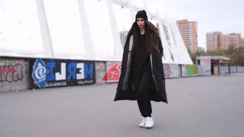 Stylish Woman Walks on City Sidewalk