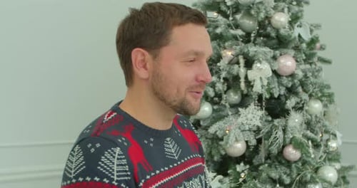 Pretty Girl Hugging with Boyfriend at Christmas Celebrating Holidays Together. Close Up of Young