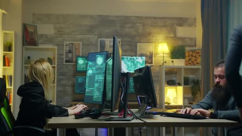 Coders Working on Computers at Night