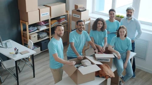 Portrait of People Volunteers Standing in Charity Company Office Smiling Looking at Camera