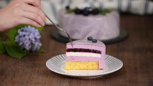 Cutting a Slice of Blueberry Layer Cake