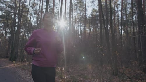 Caucasian Woman Running Along the Path in the Park