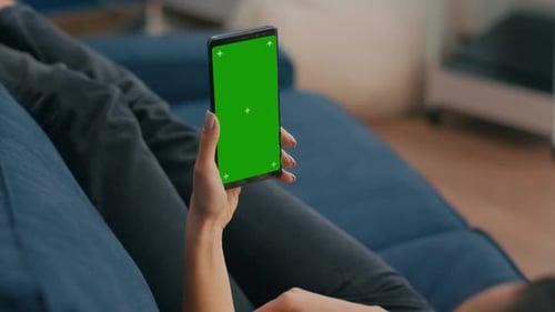 Freelancer Holding in Vertical Mode Smartphone with Mock Up Green Screen Chroma Key Display