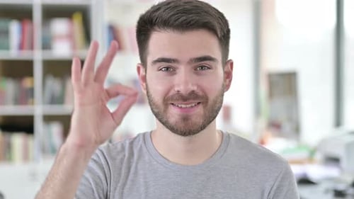 Smiling Man Gives Okay Hand Gesture Close Up