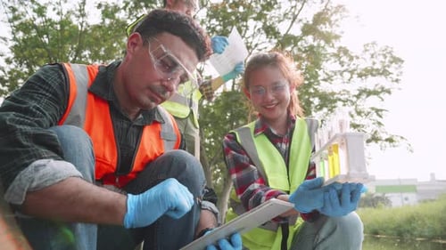 Scientists Studying Water Samples With Test Tubes