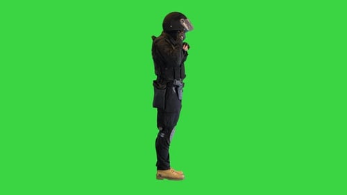 Special Police Unit Taking Helmet Off on a Green Screen Chroma Key