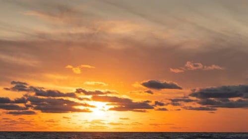 Beautiful Sunset At The Sea With Colorful Rays And Clouds