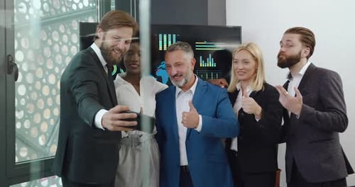 Business Team Posing for Smartphone Photo in Office