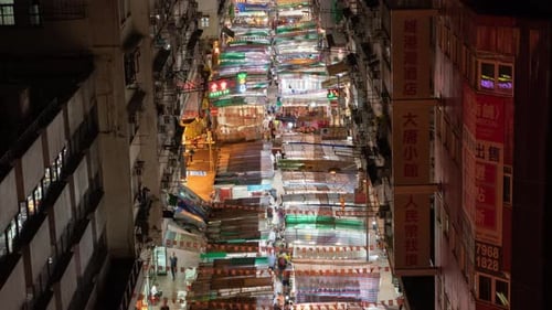 Time lapse of crowd of people walking at retail shops at night market in Monkok, Hong Kong.