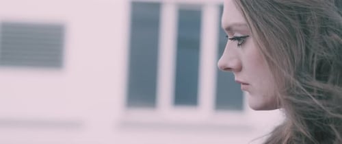 Woman's Close-Up Profile in Urban Setting