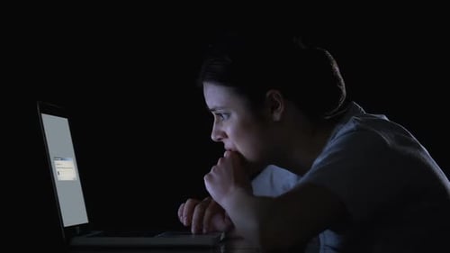 Woman Working on Laptop Late at Night