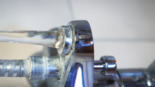 Man opening faucet in bathroom. Vertical video.