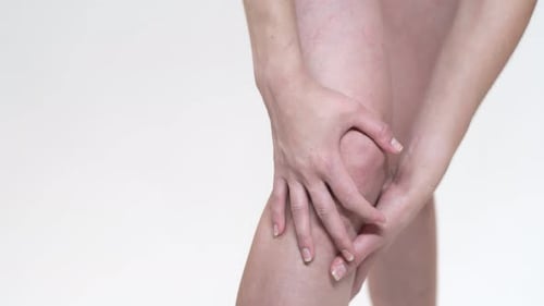 Woman Massaging Knee for Pain Relief