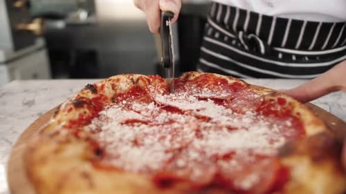 Food Culinary Italian Cuisine People and Cooking Concept Cook Hand Adding Grated Cheese to Pizza at