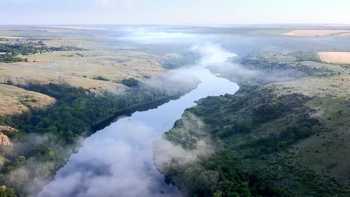 Aerial Drone View of Sunrise Over Misty River