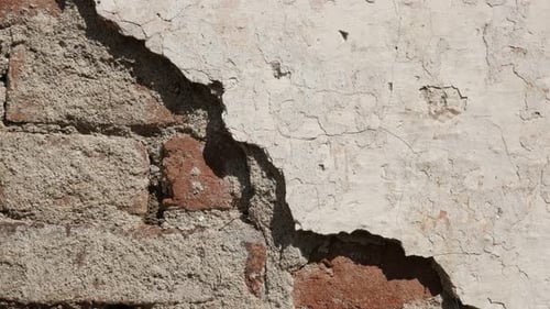 Slow tilt obsolete brick wall and white cement plaster 4K 2160p 30fps UltraHD footage - Old destro