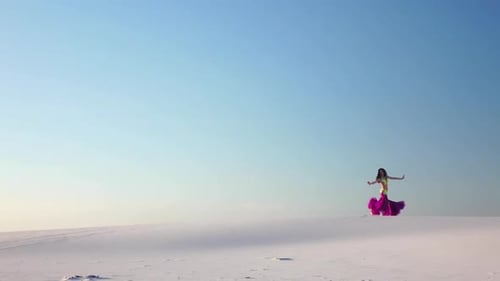 Girl Dances Belly Dancing in the Sandy Desert, Her Movements Are Unique. Slow Motion