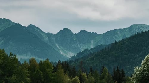 Timelapse Mountain Range Covered with Rolling Rainy Clouds
