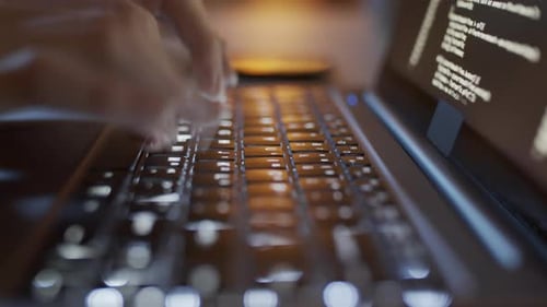 Fingers Typing Code on Laptop Keyboard Close Up