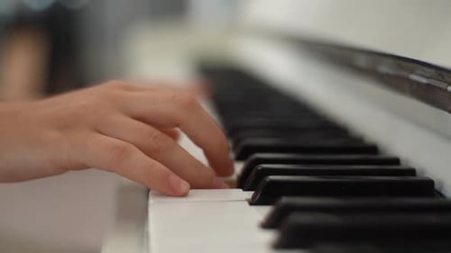 Fingers Playing White Piano Keyboard Close Up