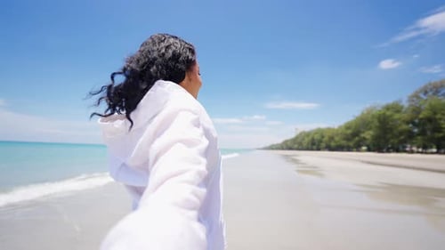 4K Portrait of Beautiful African woman walking on tropical beach in summer sunny day.