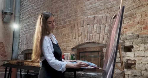 Talented Innovative Pretty Female Artist Draws with Brush on the Canvas. Contemporary Young Woman